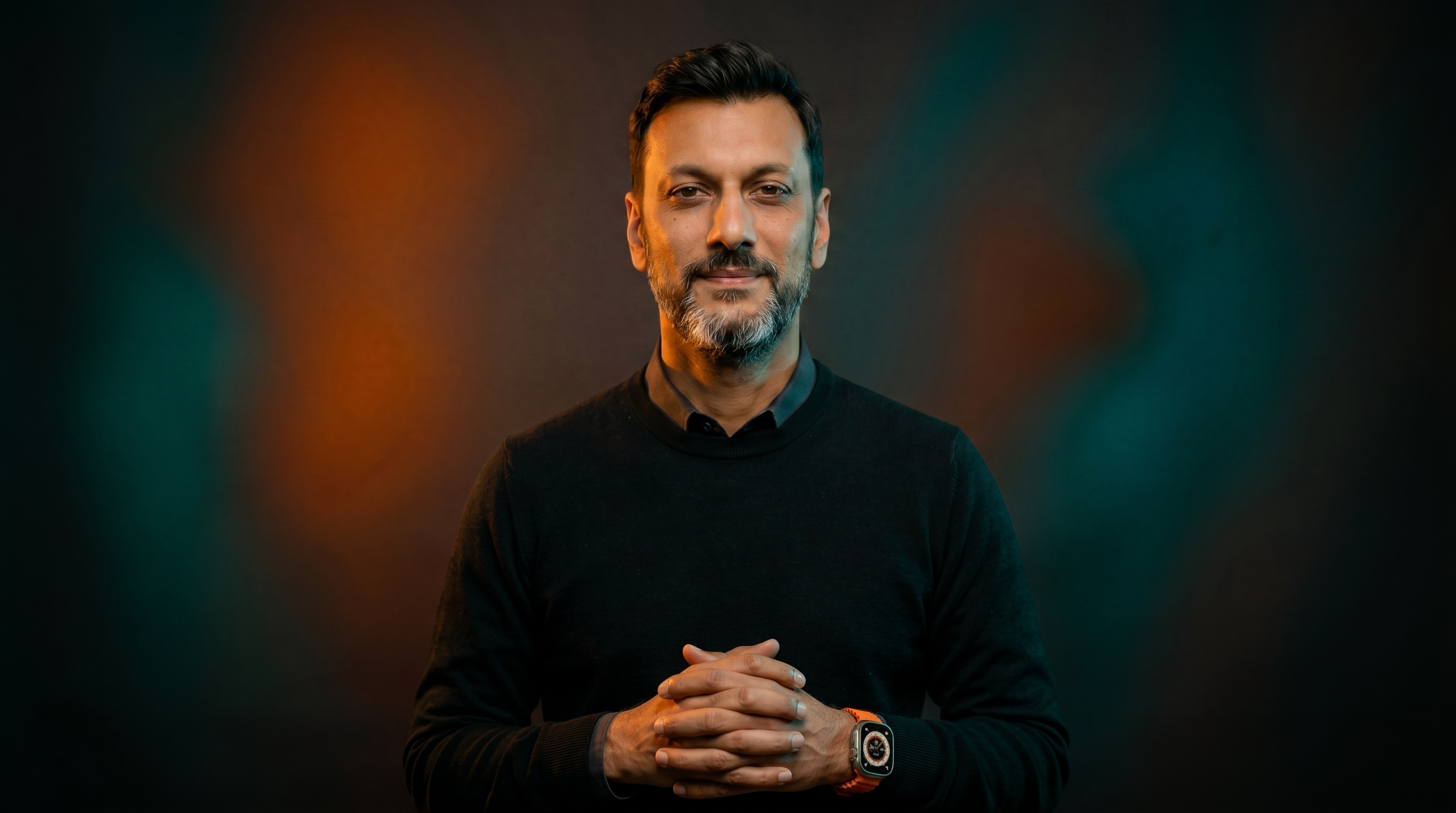 Portrait of Jigar Panchal lit in orange and teal